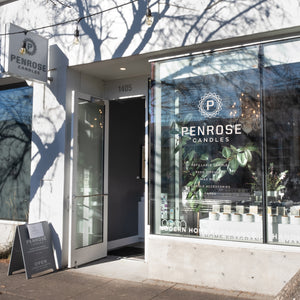 Penrose Candles flagship store exterior at 1405 showing modern storefront with large windows, brand signage, and 'Open' sidewalk sign in Portland, Oregon