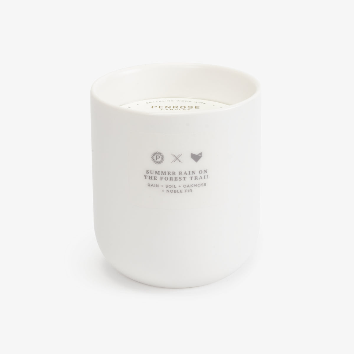 A white ceramic candle jar with a label that reads 'Summer Rain on the Forest Trail', part of the Scents of Oregon collection. 
